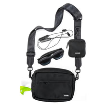 The Pawbella Crossbody Dog Walking Bag in black is shown with a matching small pouch, sunglasses, and wireless earphones on a white background. It features a zipper pocket, neon green tag, and is ideal for travel or everyday use in Australia.